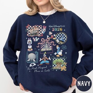 A navy blue sweatshirt with a collage of Disney-themed images, including Minnie Mouse, Mickey Mouse, Goofy, and Eeyore, along with various Disney landmarks and characters.