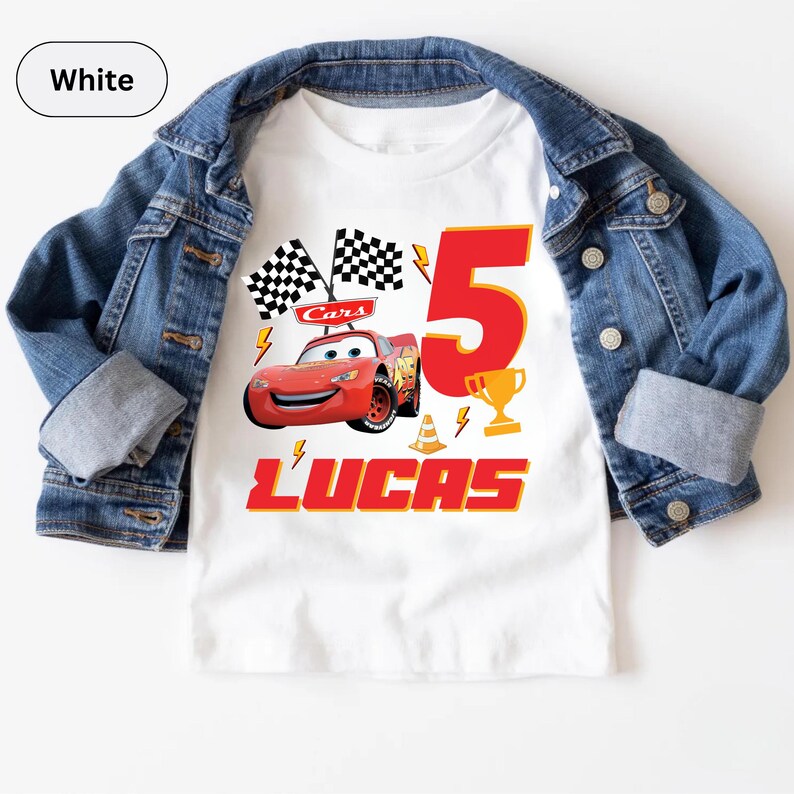 A white t-shirt with a graphic design featuring a red car and the number "5" along with the text "Lucas" and other car-related elements.