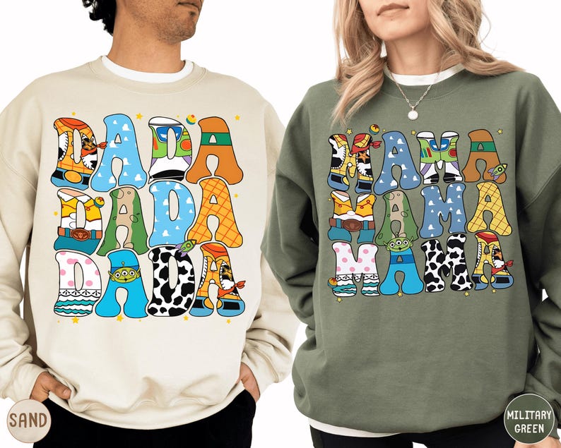two people wearing sweatshirts with colorful, cartoon-style text and characters on them.