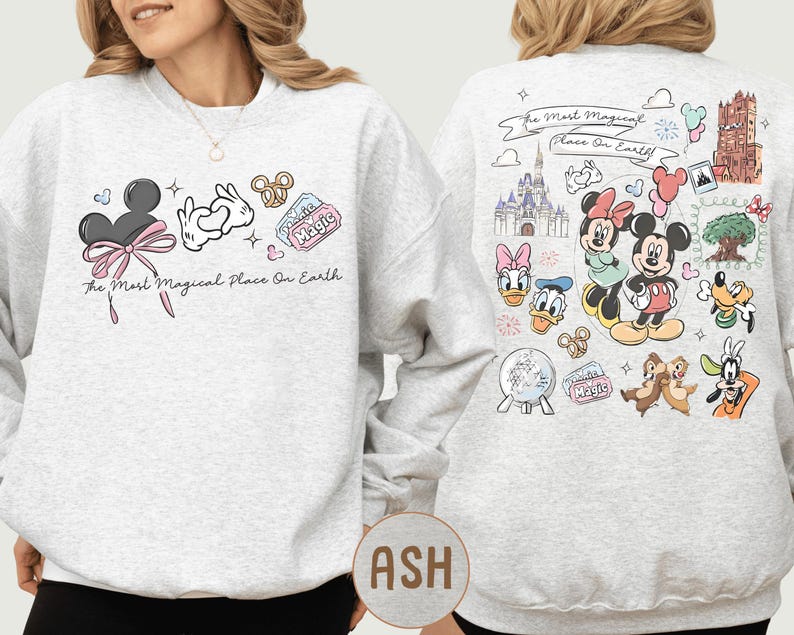 A woman wearing a white sweatshirt with various Disney characters and Disney-themed graphics printed on it.