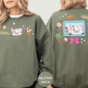 two different views of a green sweatshirt with a cartoon pig design on the front and back.