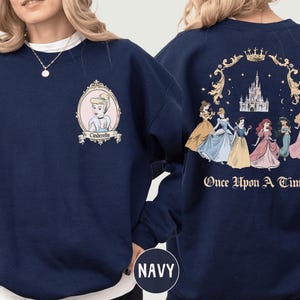 A navy blue sweatshirt with a design featuring the Disney princess characters Cinderella and the fairy tale story "Once Upon a Time".