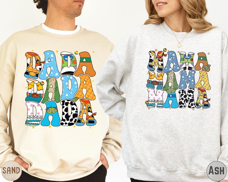 two people wearing sweatshirts with colorful, cartoon-style text and characters on them.