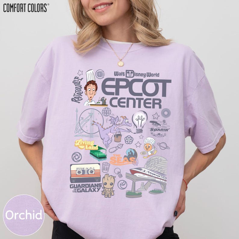 A woman wearing a purple t-shirt with various Disney-themed graphics and logos, including a chef, a roller coaster, and other iconic Disney characters and landmarks.