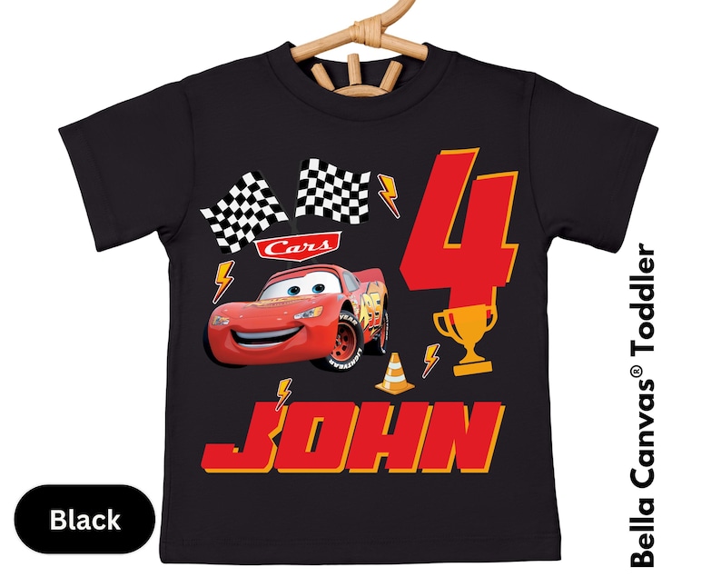 A black t-shirt with a design featuring a red car and the number 4, along with the text "Cars 4 JOHN".