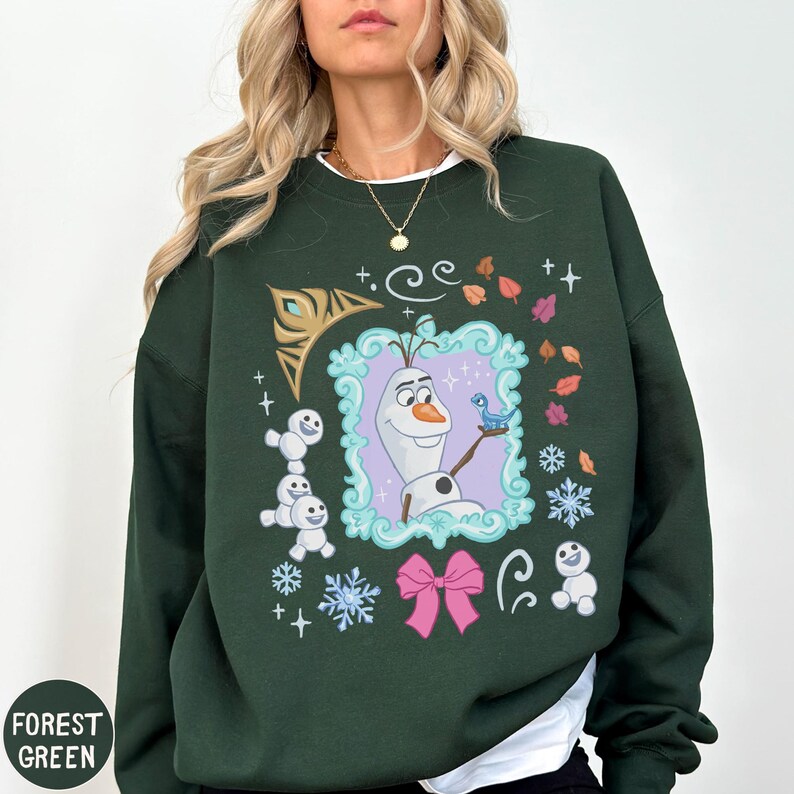 A woman wearing a green sweater with a graphic of a character from the Disney movie Frozen.