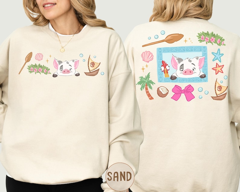 a woman wearing a white sweatshirt with a colorful and whimsical design on the back.