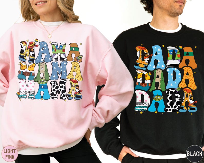 Two people wearing sweatshirts with colorful text and graphics on them.