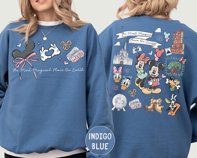A woman wearing a blue sweatshirt with various Disney characters and Disney-themed graphics printed on it.