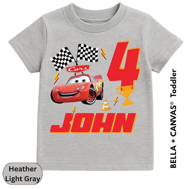 A gray t-shirt with a graphic design featuring a red car and the number 4, along with the text "Cars 4 JOHN".