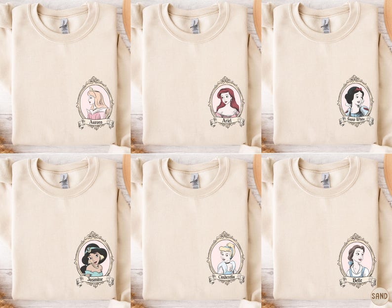 six beige t-shirts with cartoon portraits of princesses and the names "Aria", "Annie", "Annie", "Annie", "Annie", and "Annie" printed on them.