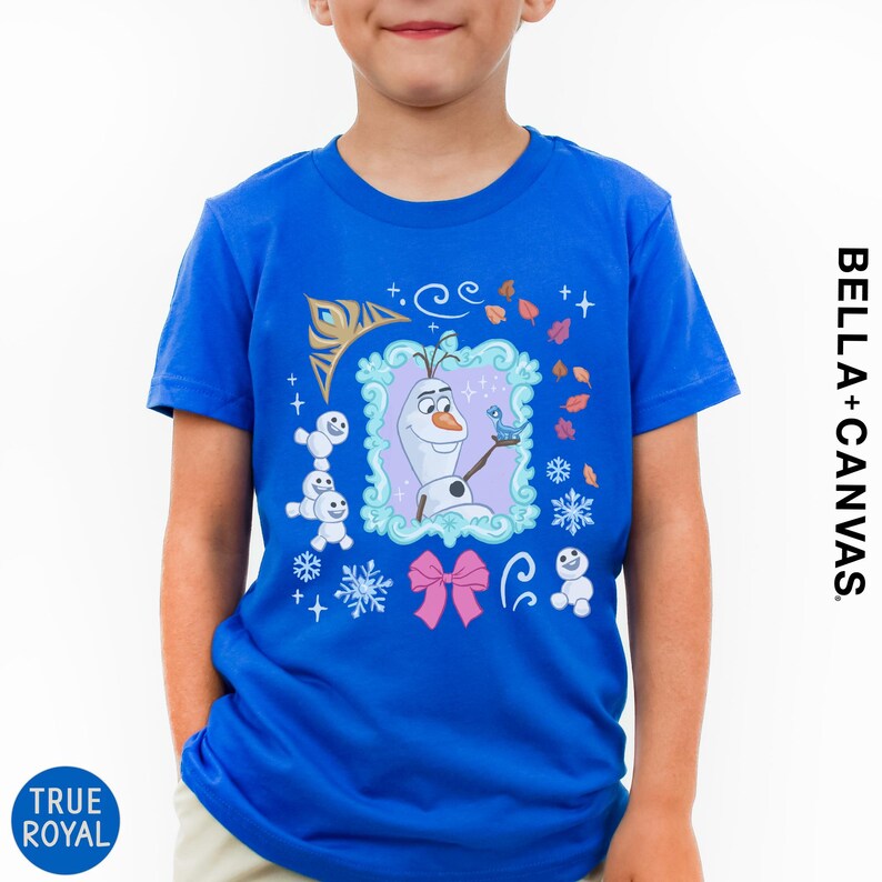 A young boy wearing a blue t-shirt with a graphic of a snowman and various snow-themed elements.