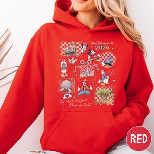 A red hoodie with a collage of Disney-themed images and text, including characters and landmarks from Walt Disney World.