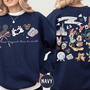 A navy blue sweatshirt with various Disney characters and Disney-themed graphics printed on it.
