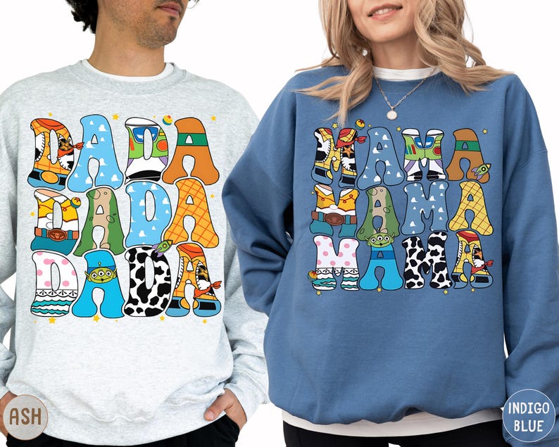 two people wearing sweatshirts with a colorful, cartoon-style design.
