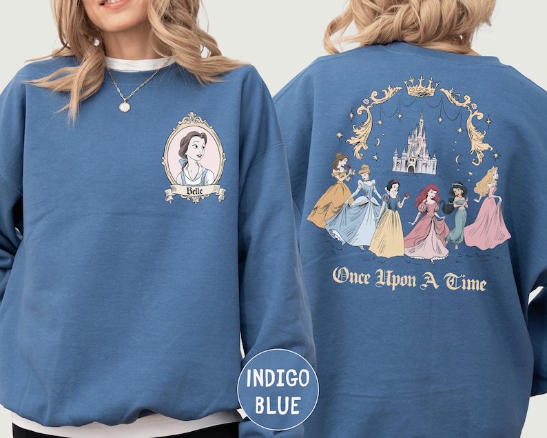 A woman wearing a blue sweatshirt with a Disney princess design on the front and a castle illustration on the back.