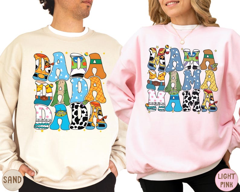 two people wearing sweatshirts with colorful text and graphics.