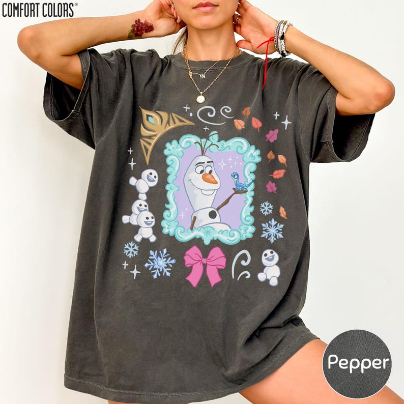 A person wearing a black t-shirt with a graphic design featuring characters from the Disney movie Frozen.