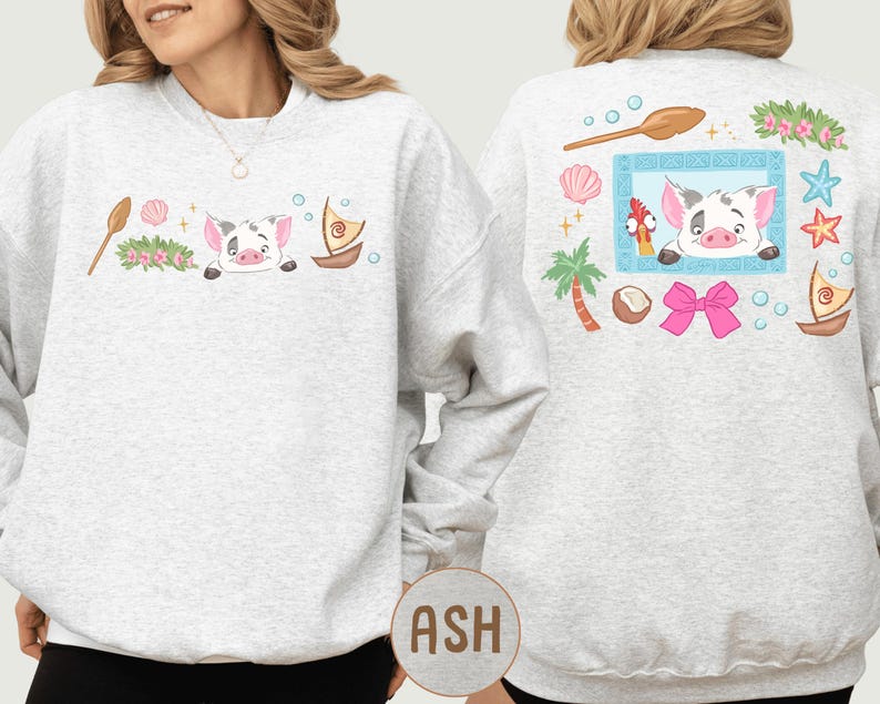 A woman wearing a gray sweatshirt with a cartoon pig design and various tropical elements on the back.