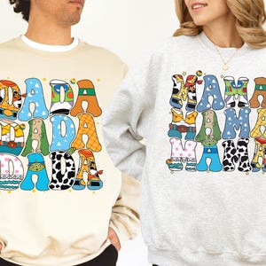 two people wearing sweatshirts with a colorful, cartoon-style design.