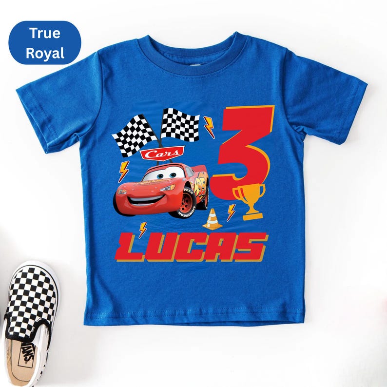 A blue t-shirt with a design featuring a red car and the number 3, along with the text "Cars 3 LUCAS".