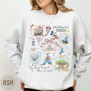 A woman wearing a gray sweatshirt with a collage of Disney characters and landmarks printed on it, along with the text "Disney World 2020" and "The most magical place on Earth".