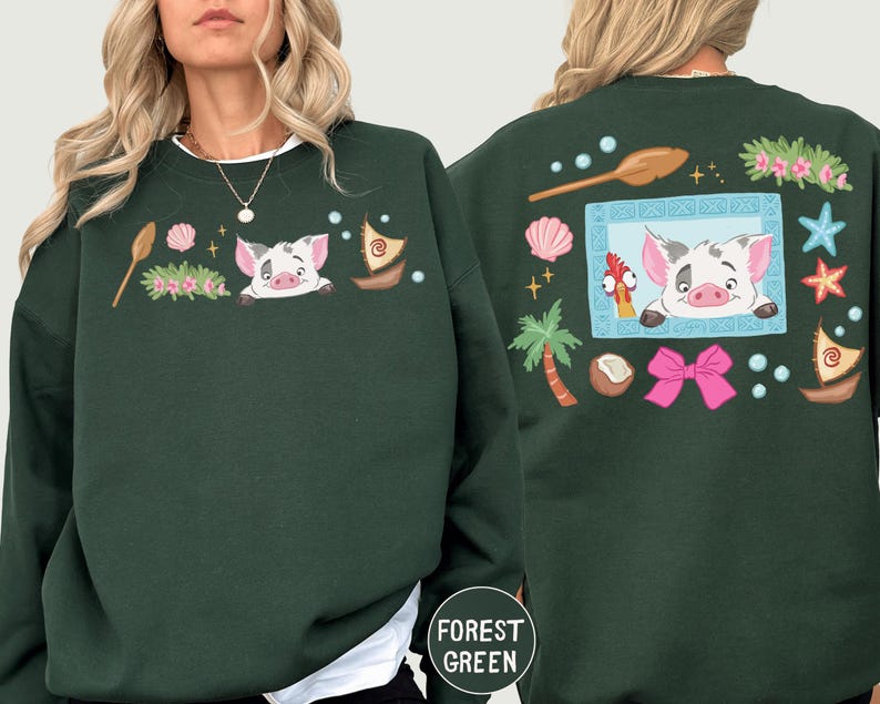 A woman wearing a green sweatshirt with a cartoon pig design and various other colorful elements.
