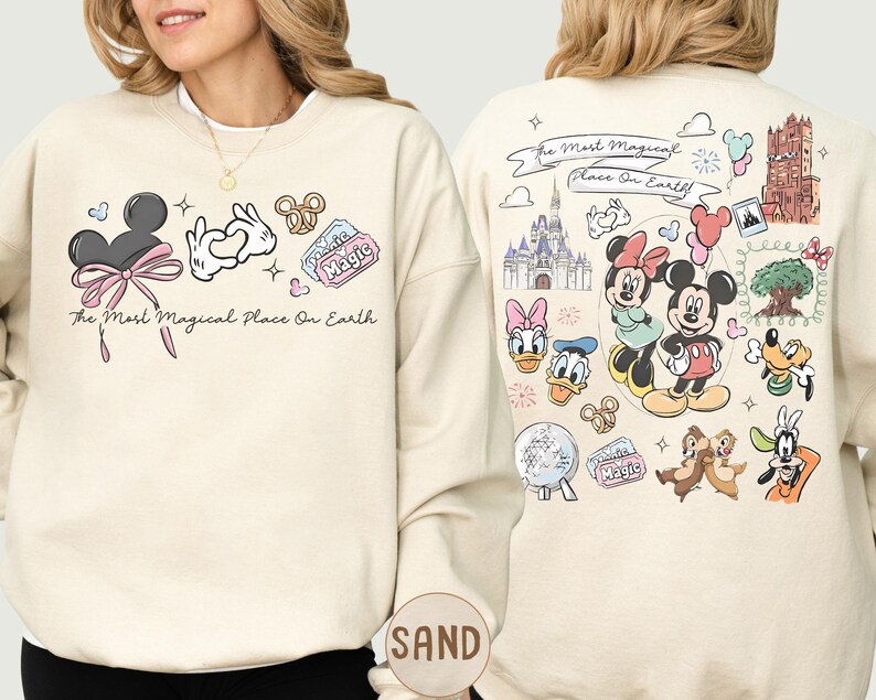 A woman wearing a white sweatshirt with various Disney characters and Disney-themed graphics printed on it.