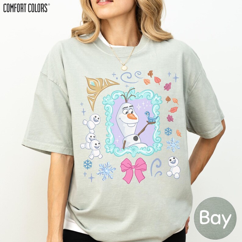 A woman wearing a t-shirt with a graphic design featuring characters from the Disney animated film Frozen.