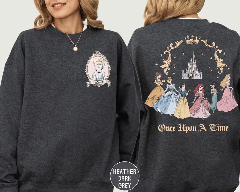 A woman wearing a gray sweatshirt with a design featuring the Disney princess characters Cinderella and the text "Once Upon a Time" on the back.