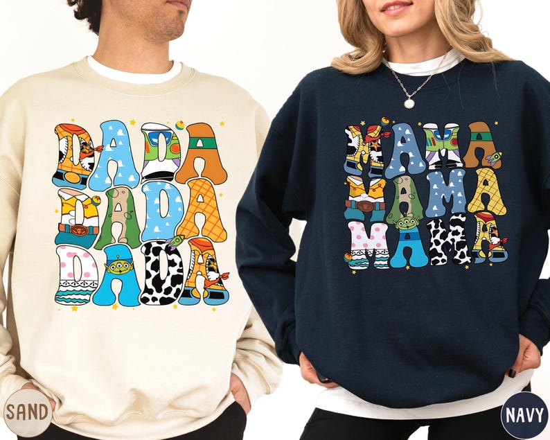 two people wearing sweatshirts with colorful text and graphics.
