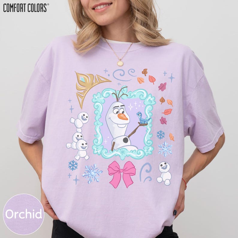 A woman wearing a pink t-shirt with a graphic design featuring characters from the Disney movie Frozen.