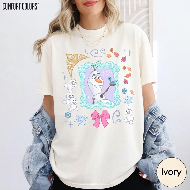 A woman wearing a white t-shirt with a graphic design featuring characters from the Disney movie Frozen.