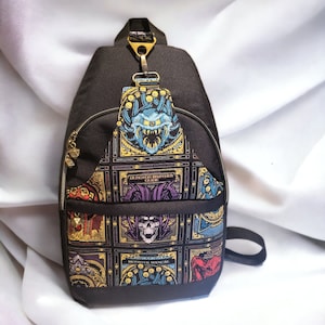 May include: A black canvas sling bag with a Dungeons & Dragons theme. The bag features a colorful graphic print of various monsters and creatures from the game, including a Beholder, a Mind Flayer, and a Gelatinous Cube. The bag has a zippered pocket on the front and an adjustable strap.