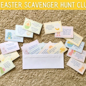 May include: A set of 16 Easter scavenger hunt clues printed on colorful cards with bunny and chick illustrations. The cards are scattered on a beige carpet with a white envelope in the center.