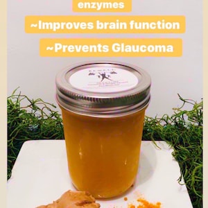 K&ouml;nnte beinhalten: Ein Glasgef&auml;&szlig; gef&uuml;llt mit einer gelben Fl&uuml;ssigkeit mit der Aufschrift "BE WELL" Kurkuma & Ingwer-infusiertes Meeresmoos-Gel. Das Gef&auml;&szlig; steht auf einer wei&szlig;en Oberfl&auml;che mit einem St&uuml;ck Ingwer und Kurkumapulver.