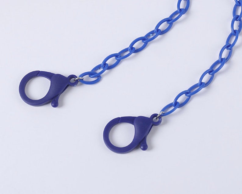 May include: A blue plastic chain with two blue plastic clasps. The chain is approximately 20 inches long.