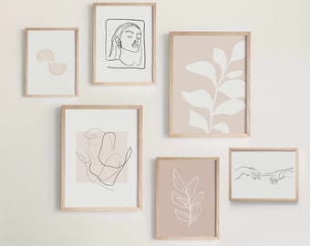 Könnte beinhalten: Eine Sammlung gerahmter Kunstdrucke mit minimalistischen Designs. Die Drucke zeigen Strichzeichnungen von Gesichtern, Händen und botanischen Elementen in neutralen Farben. Die Rahmen sind aus hellem Holz, was einen modernen und ruhigen Eindruck erzeugt.
