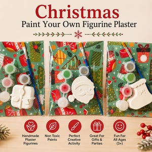 May include: Three Christmas paint your own plaster figurine kits in clear plastic packaging. Each kit includes a white plaster shape, a small paintbrush, and a strip of paint pots. The packaging features a festive green background with red and gold gift patterns.