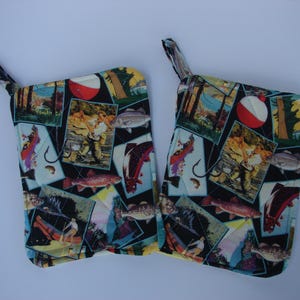 May include: Two colorful pot holders with a fishing theme. The pot holders are made of fabric and feature a variety of images, including fish, fishing lures, and fishing rods. The pot holders are a great way to add a touch of personality to your kitchen.