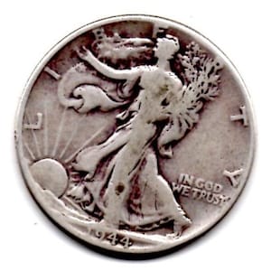 May include: A silver 1944 Walking Liberty half dollar coin. The coin features Lady Liberty walking towards the sun, holding branches, with the words "IN GOD WE TRUST". The year "1944" is visible.