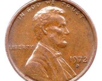 Op de afbeelding: Een koperkleurige Amerikaanse cent met de inscriptie "IN GOD WE TRUST" en "LIBERTY" op de voorzijde. De munt toont een profiel van Abraham Lincoln en de datum "1972".