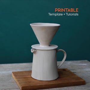 May include: A ceramic pour-over coffee maker set in a neutral color, including a cone-shaped dripper, a base, and a matching carafe. The set is placed on a wooden board, with the text "PRINTABLE Template + Tutorials" in the upper right corner.
