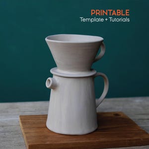 May include: A light grey ceramic pour-over coffee maker with a cone-shaped filter holder and a carafe. The coffee maker is on a wooden board, with the text "PRINTABLE Template + Tutorials" in orange and white.