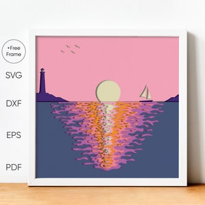 May include: Framed art print depicting a sunset over the ocean. The image features a lighthouse, sailboat, and sun against a pink sky. The water reflects the sunset's colors, with text on the left side indicating file formats.