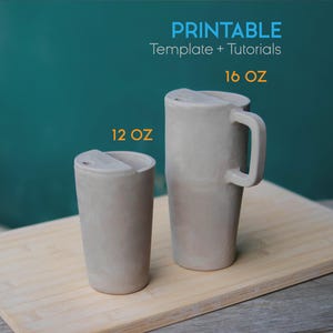 May include: Two gray ceramic travel mugs with lids, one 12 oz and one 16 oz, sit on a wooden board. The larger mug has a handle. Text at the top reads "PRINTABLE Template + Tutorials".
