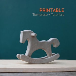 May include: A light-colored wooden rocking horse figurine. The toy horse is on a wooden surface, with a teal background. The text "PRINTABLE Template + Tutorials" is in orange.