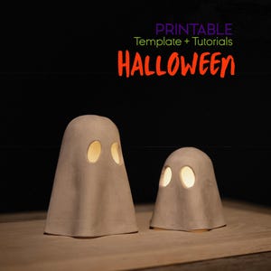 May include: Two beige ghost-shaped Halloween decorations with glowing eye cutouts. The larger ghost is on the left, and the smaller one is on the right. The word "HALLOWEEN" is in orange text above the ghosts.