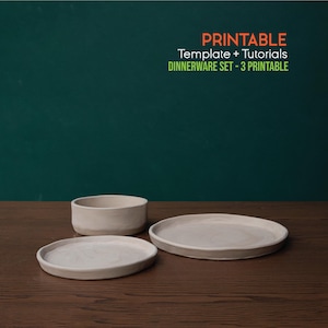 May include: A set of three off-white ceramic dinnerware pieces: a small bowl and two plates of different sizes. The text "PRINTABLE Template + Tutorials DINNERWARE SET - 3 Printable" is displayed in orange and green.