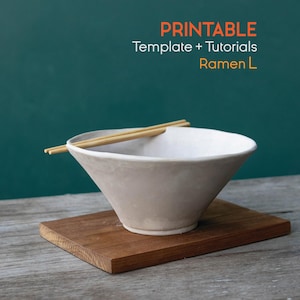 May include: A beige ramen bowl with a wide rim and a wooden base, holding a pair of chopsticks. The text "PRINTABLE Template + Tutorials Ramen L" is displayed in orange and yellow.